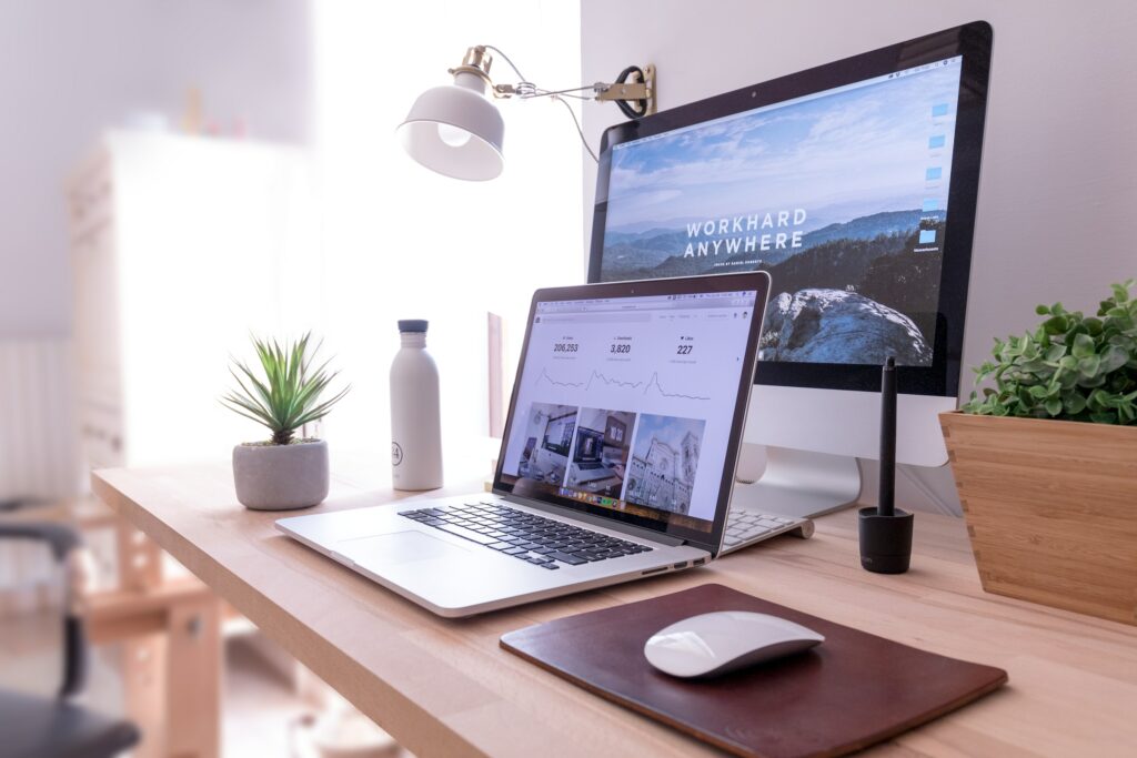 work desk with a desktop and a laptop