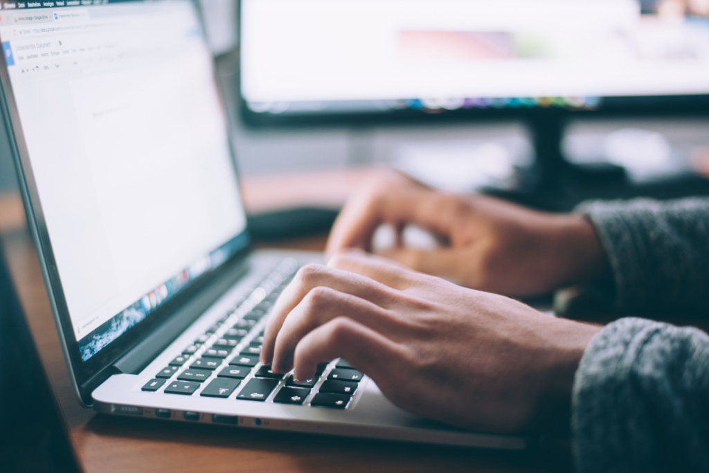 picture showing hands typing on a laptop