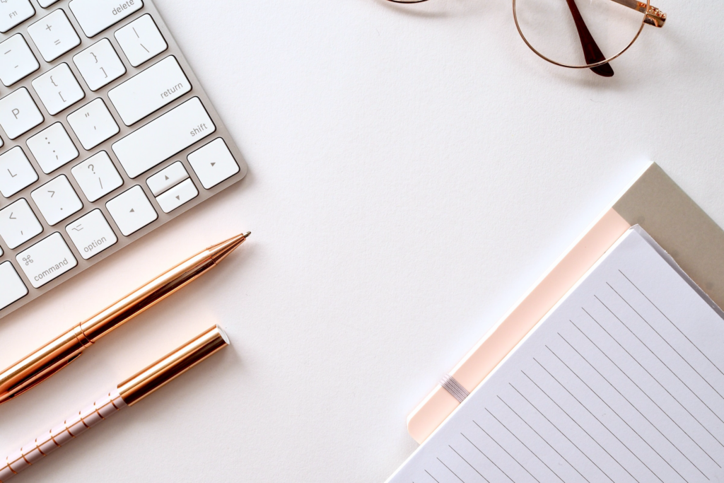 keyboard, pens, notebooks and glasses